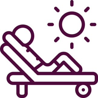 Person relaxing in the sun on a lounge chair.